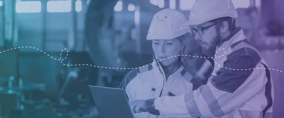 Engineers collaborate on plans on a digital tablet in a STEM workplace environment